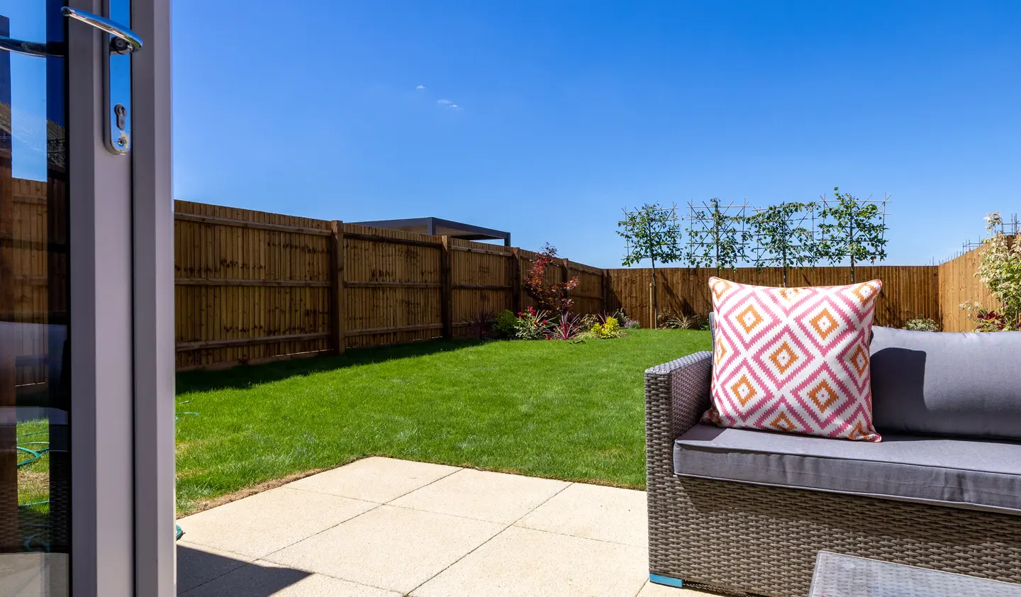 Durkan home garden with lawn, paved area and outdoor seating