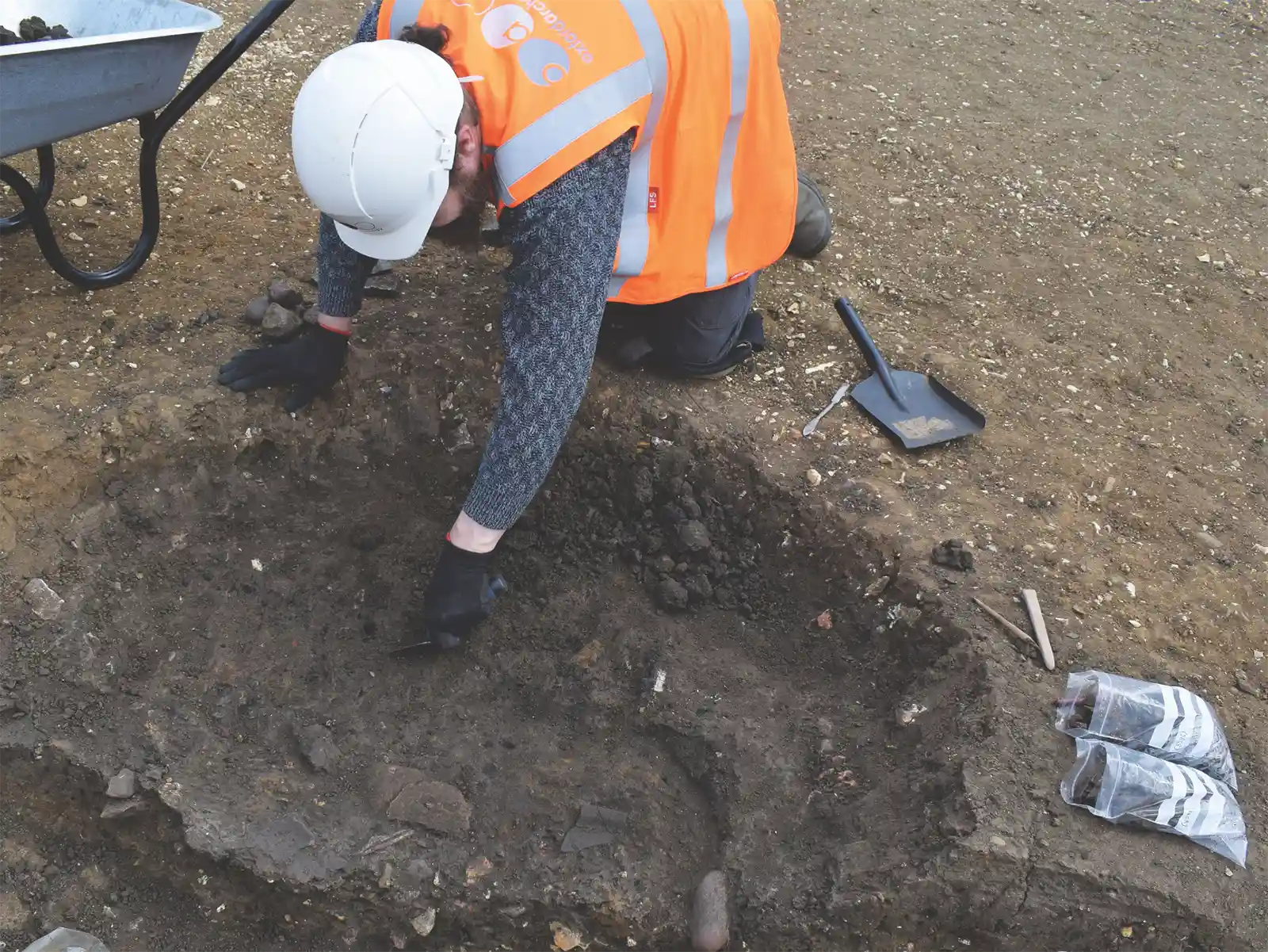Archaeologist excavating a trench