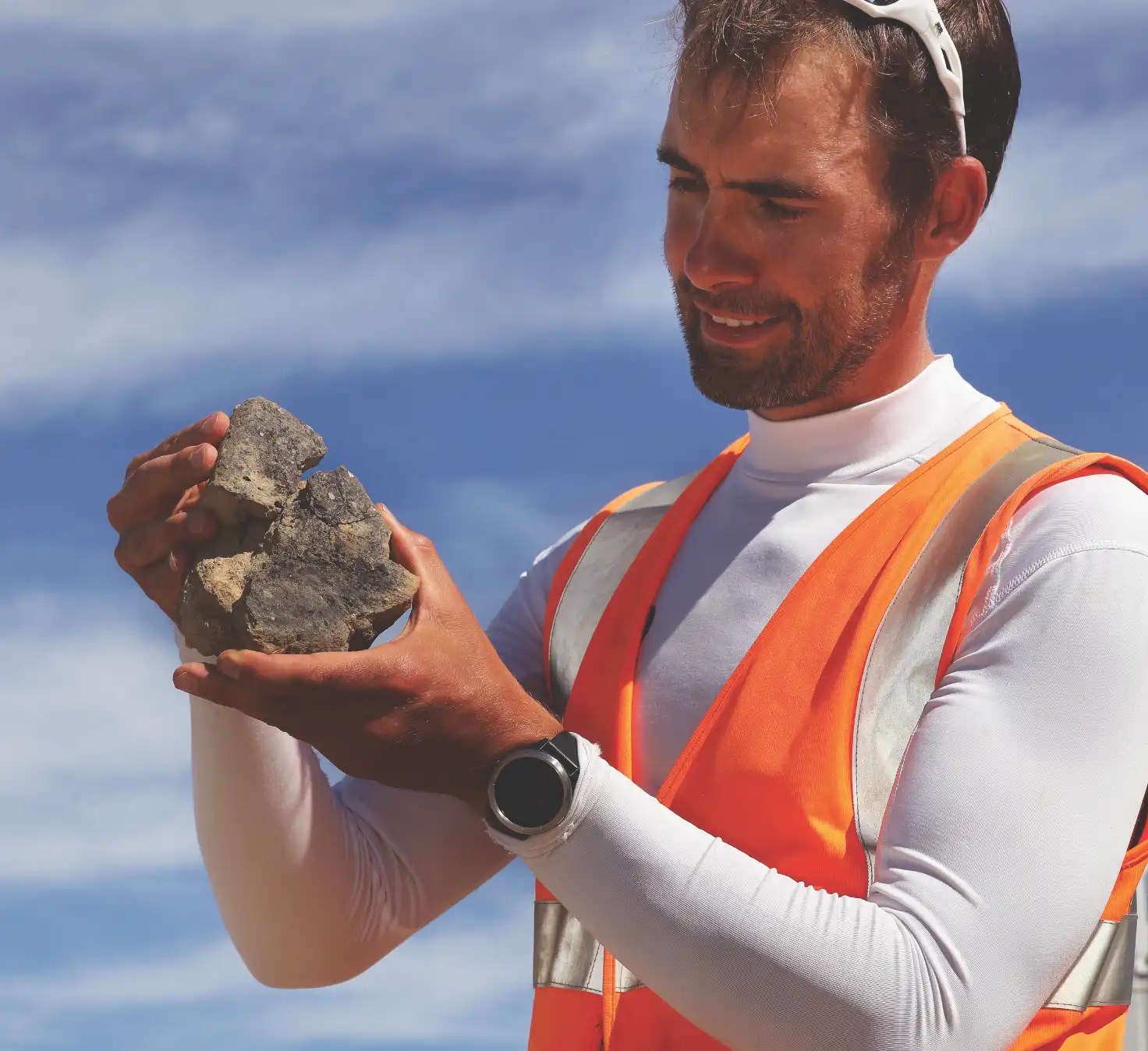 Archaeologist in the field studying a rock