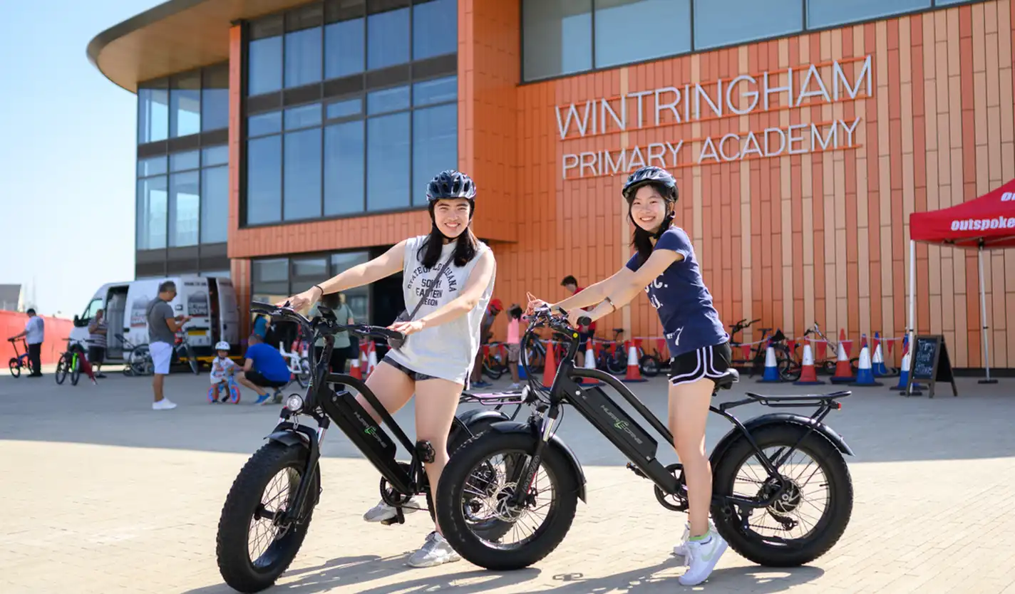 Two girls on bikes at Wintringham School Plaza