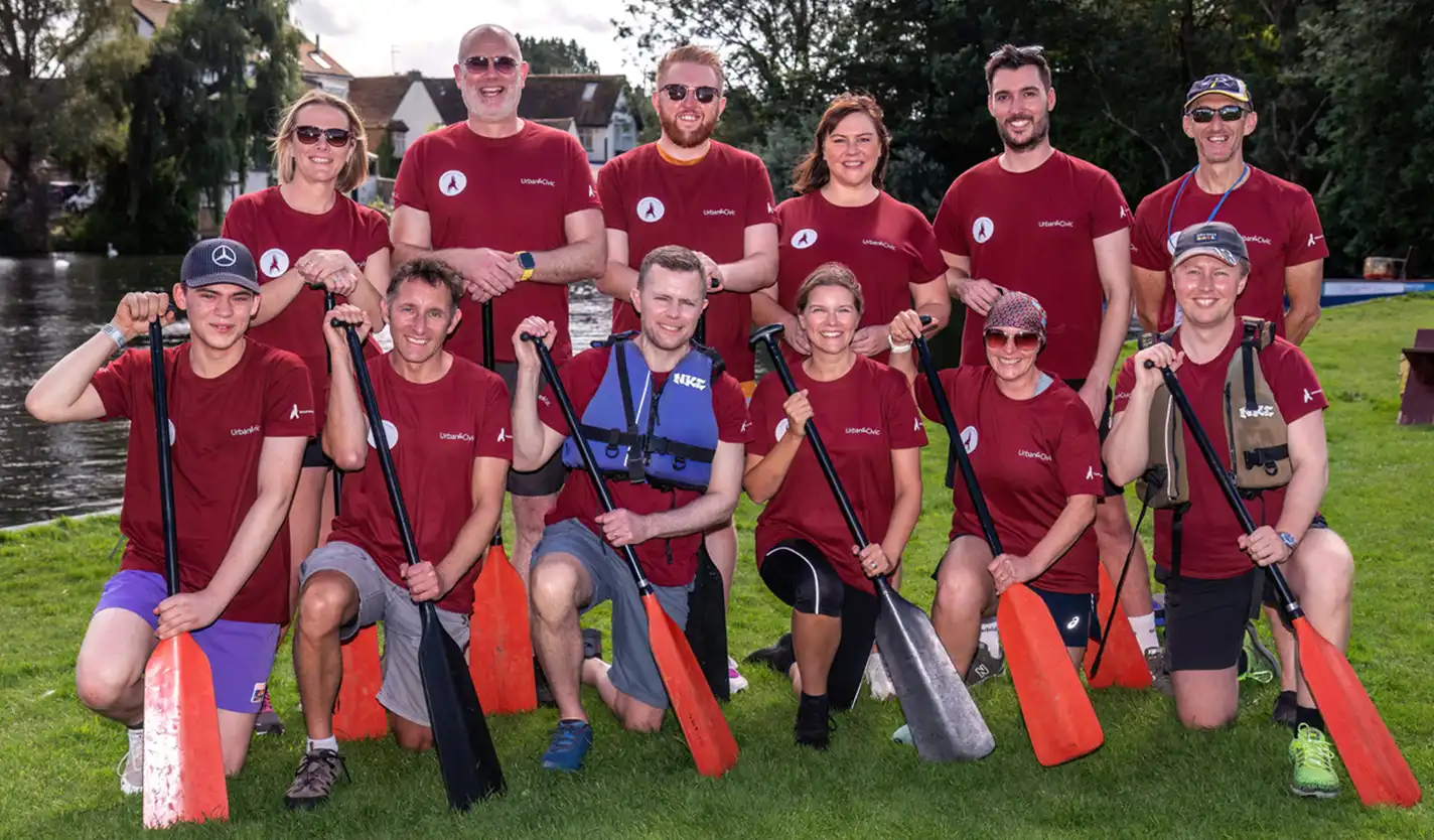 The Wintringham Wagtails dragon boat team, posing on the riverbank with oars